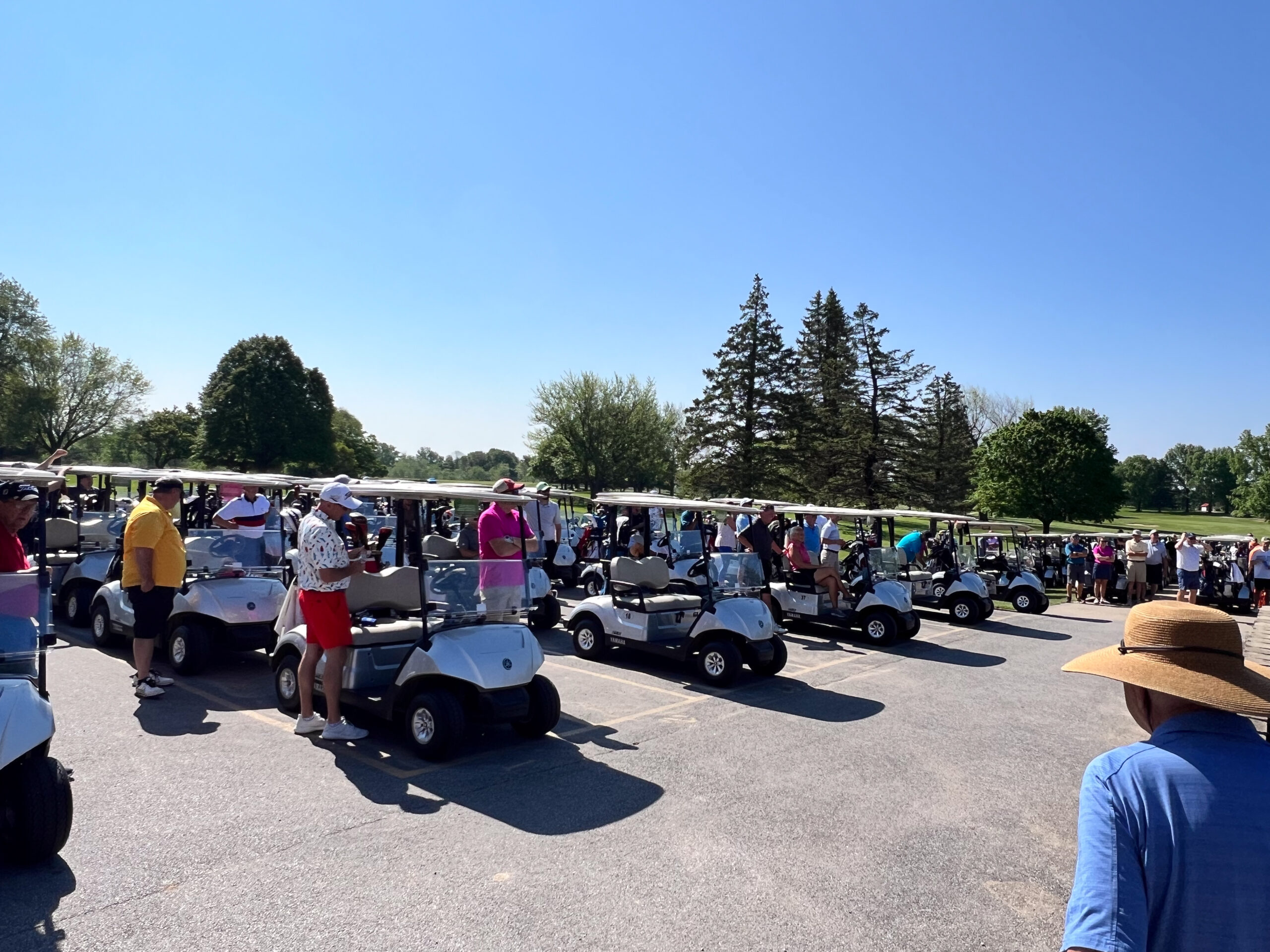 Two employees sitting in a golf cart