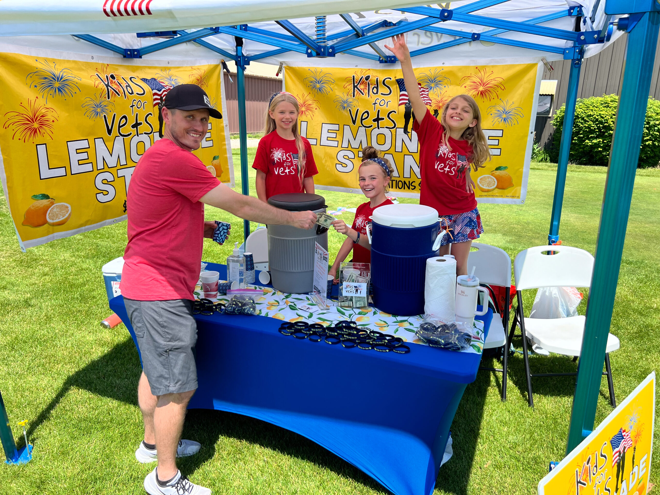 Kids stand at their Kids for Vets Lemonade Stand